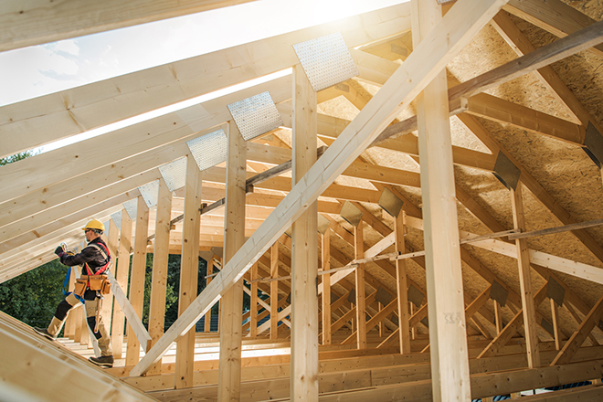 Wooden Roof Skeleton Frame of Building, Construction Contractor Worker Building Wooden Roof Skeleton Frame of the Building. Industrial Theme.