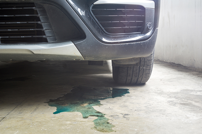 Car parked with water coolant liquid leak out from the engine do